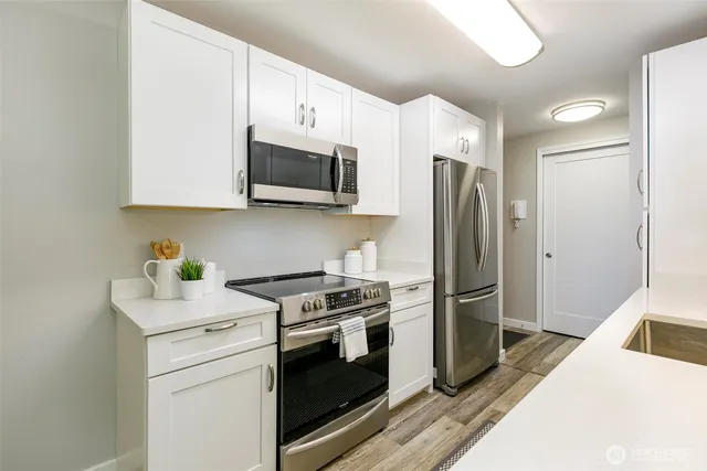 a kitchen with stainless steel appliances a refrigerator stove and microwave