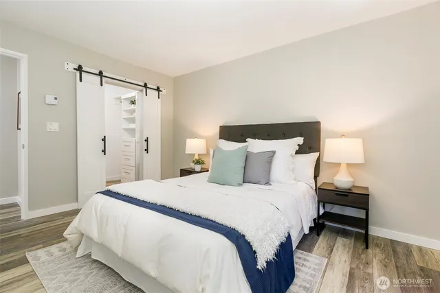 a bedroom with a bed and a mirror