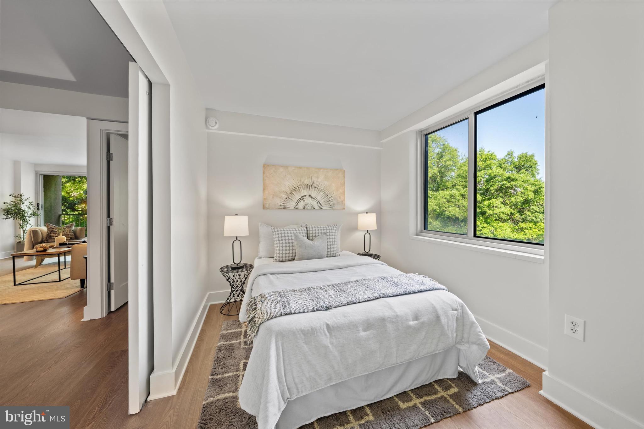 800 4th Street Southwest, Unit N501 Washington, DC 20024 - Photo 11 of 16 a bedroom with a bed and a large window