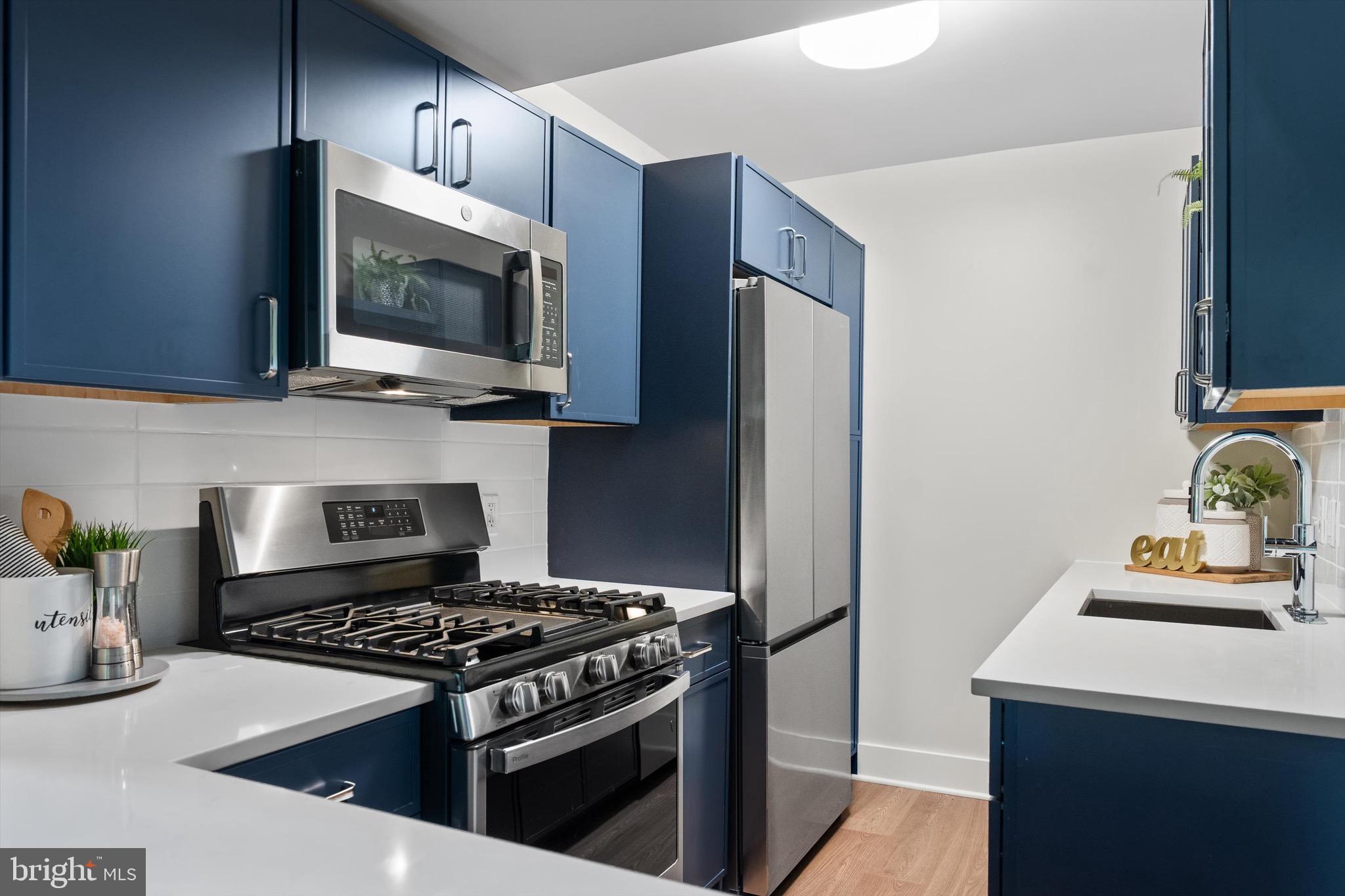 800 4th Street Southwest, Unit N501 Washington, DC 20024 - Photo 5 of 16 a kitchen with stainless steel appliances a stove a microwave and cabinets