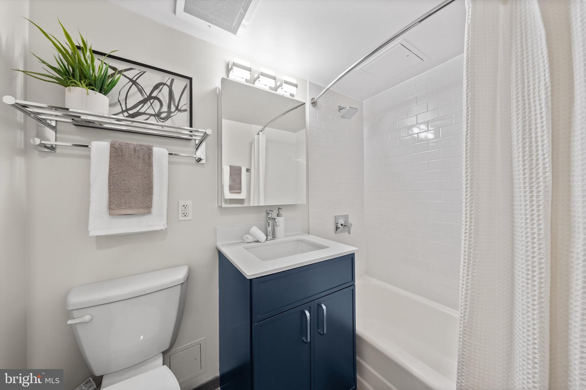 800 4th Street Southwest, Unit N501 Washington, DC 20024 - Photo 10 of 16 a bathroom with a toilet sink and mirror