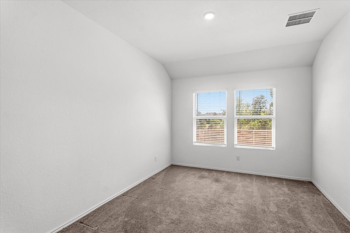 167 Jeffers Kyle, TX 78640 - Photo 19 of 40 Carpeted empty room featuring vaulted ceiling and baseboards