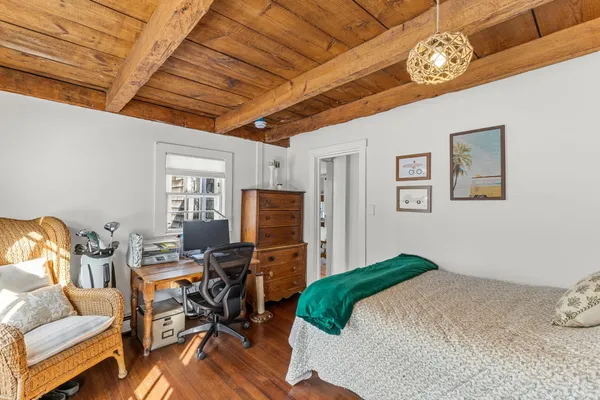 a bedroom with a large bed and a window