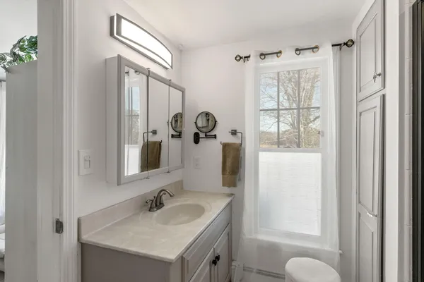 a bedroom with furniture and natural light