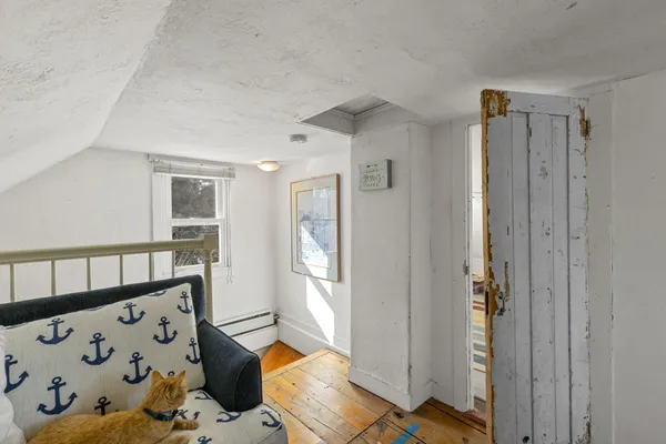 a bedroom with a large bed and a chair