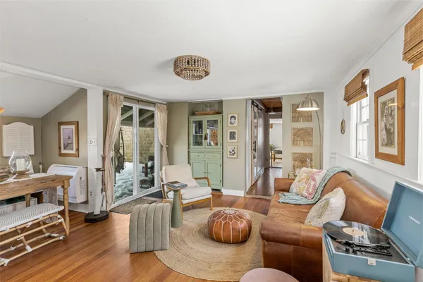 a living room with furniture and a floor to ceiling window