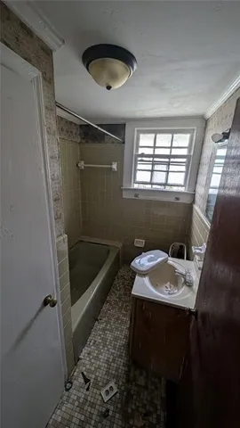 a bathroom with a sink a toilet and tub