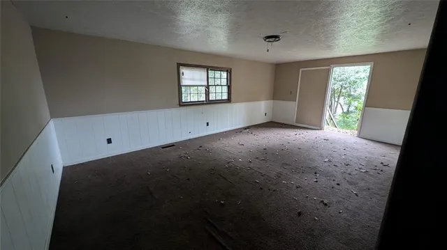 a view of a livingroom with an empty space and window