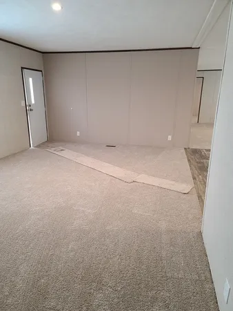 an empty room with staircase and mirror