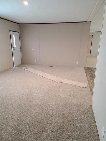 an empty room with staircase and mirror