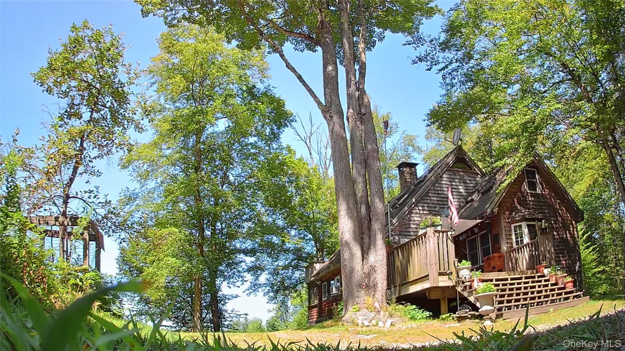 a view of a house with a tree in front