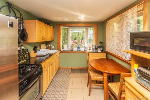 a dining area with furniture and a large window