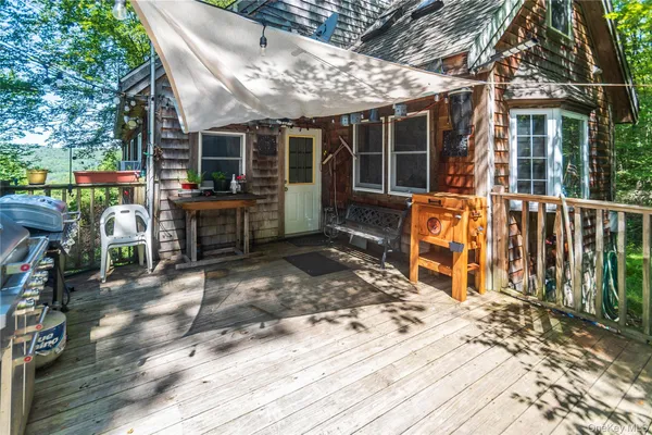 a view of a patio with table and chairs and wooden floor