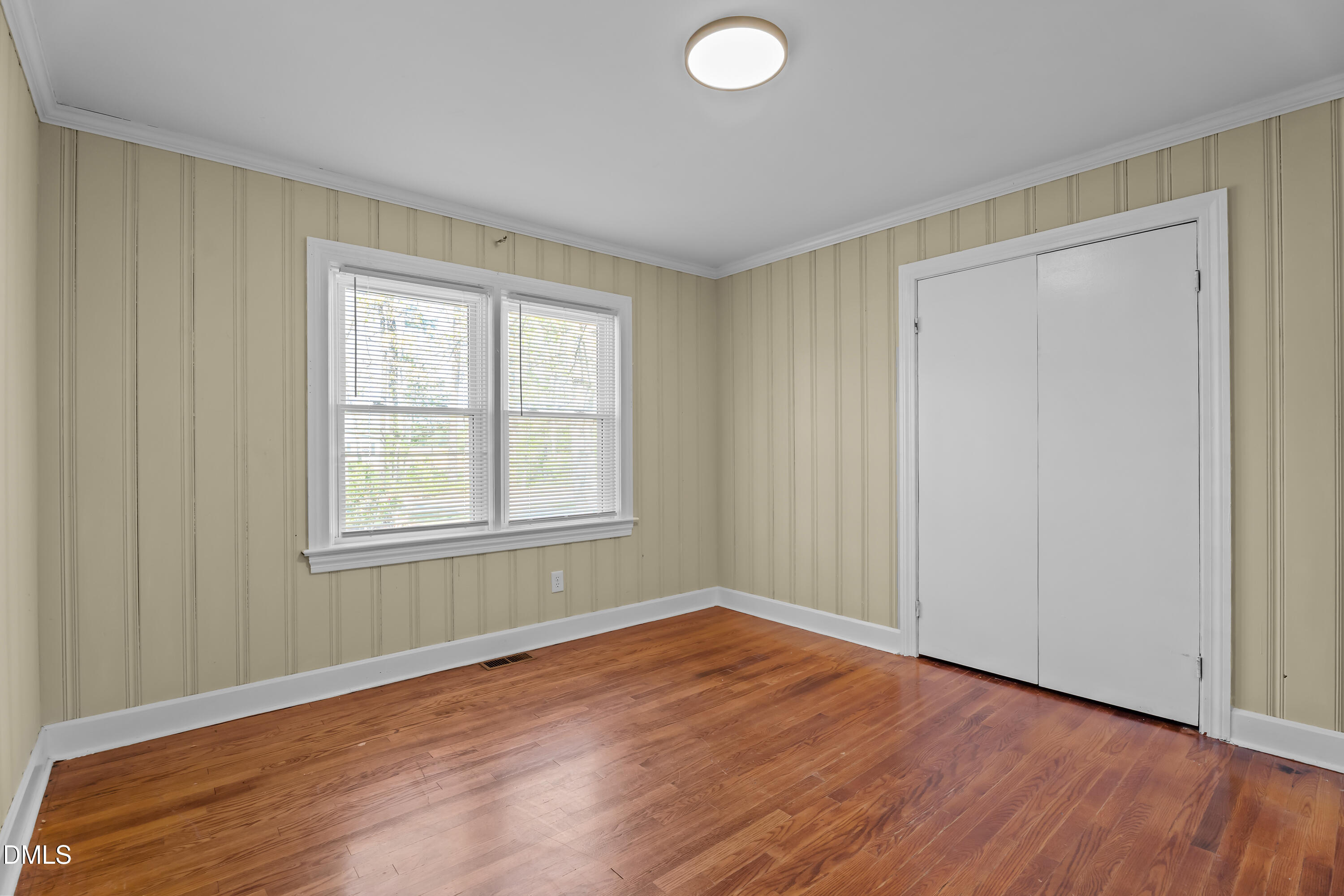 4149 Woodcrest Road Rocky Mount, NC 27803 - Photo 18 of 43 an empty room with wooden floor and windows