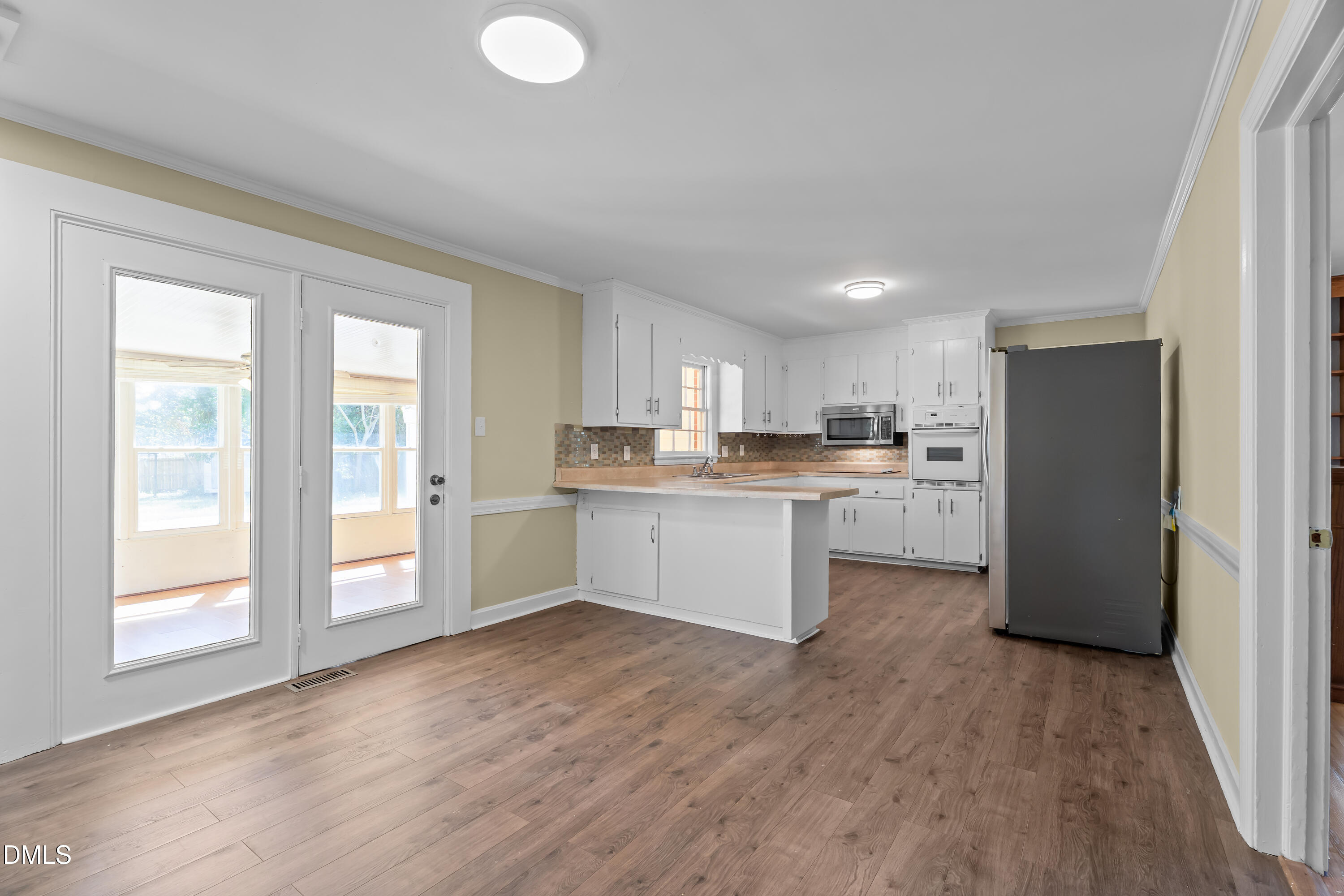 4149 Woodcrest Road Rocky Mount, NC 27803 - Photo 19 of 43 a kitchen with stainless steel appliances granite countertop a refrigerator a sink dishwasher and a stove with wooden floor