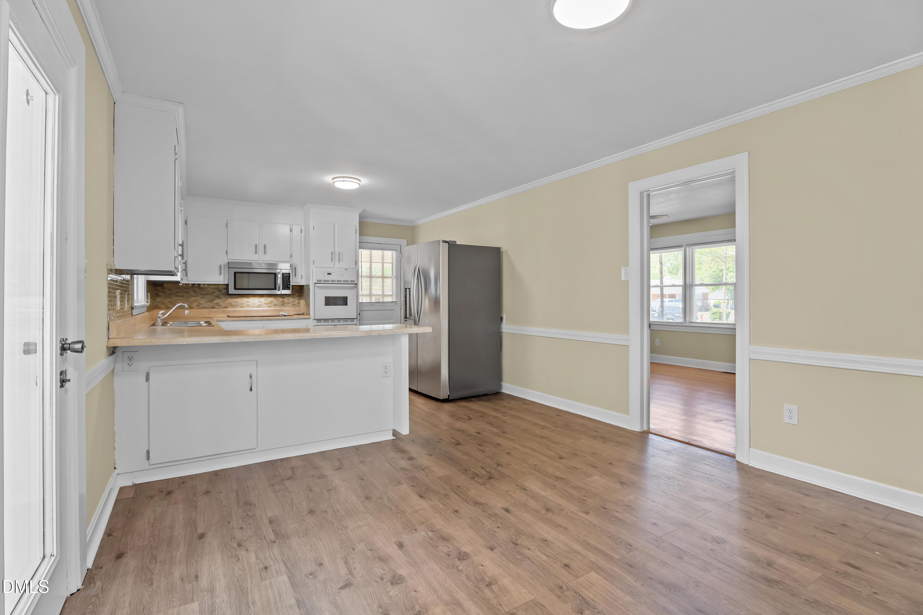 4149 Woodcrest Road Rocky Mount, NC 27803 - Photo 26 of 43 a kitchen with a refrigerator and cabinets