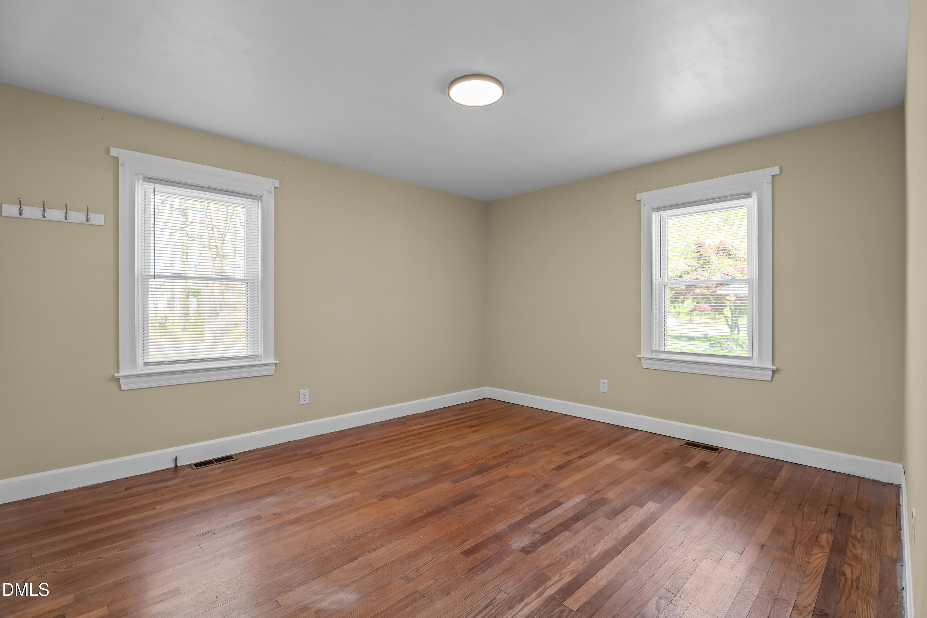 4149 Woodcrest Road Rocky Mount, NC 27803 - Photo 29 of 43 a view of an empty room with wooden floor and a window