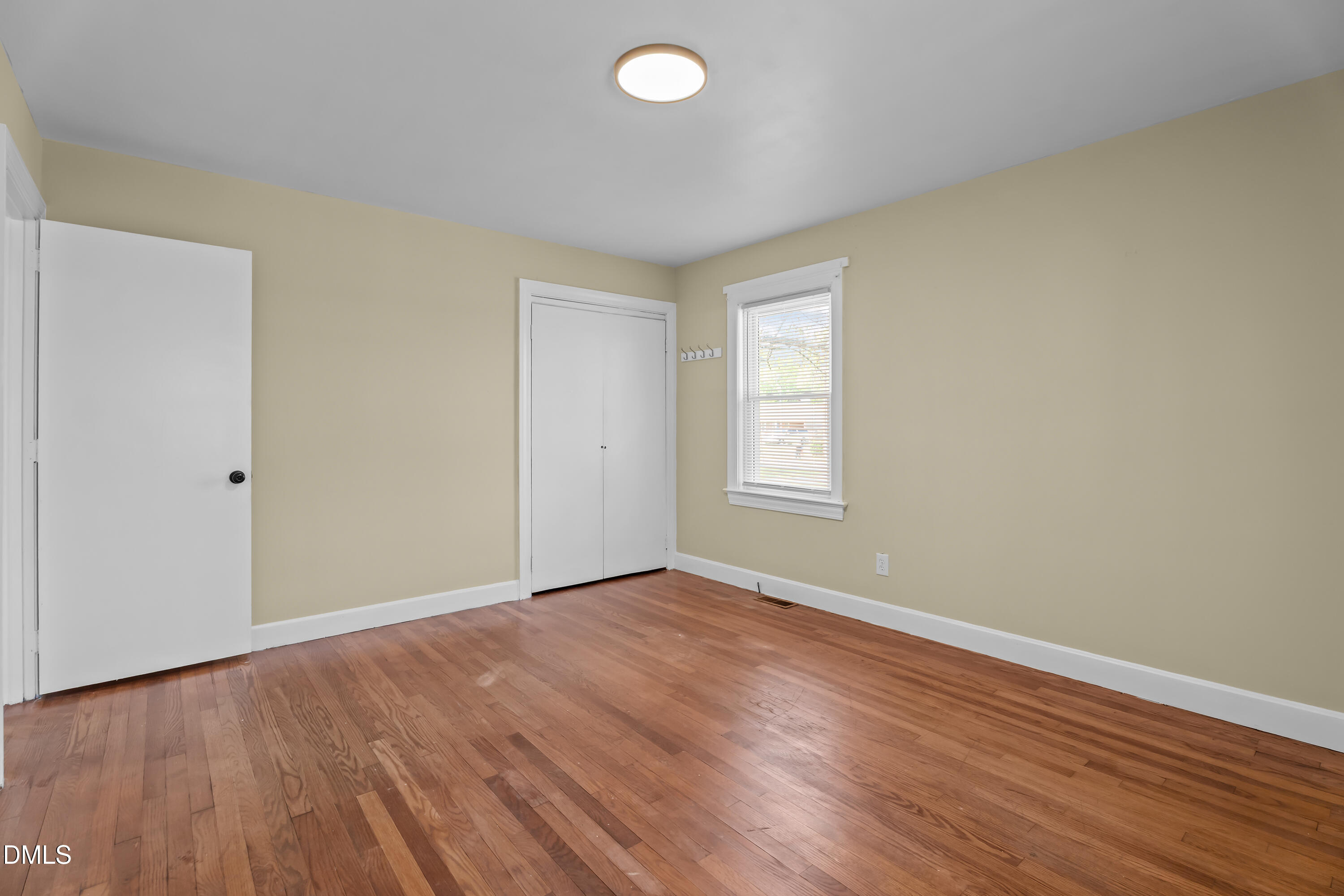 4149 Woodcrest Road Rocky Mount, NC 27803 - Photo 33 of 43 an empty room with wooden floor and windows