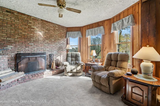 a kitchen with stainless steel appliances granite countertop a stove kitchen island a table and chairs