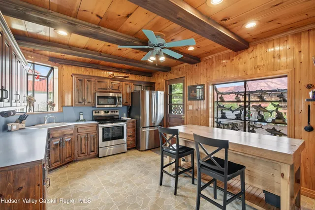 a kitchen with stainless steel appliances granite countertop a sink a stove and a refrigerator