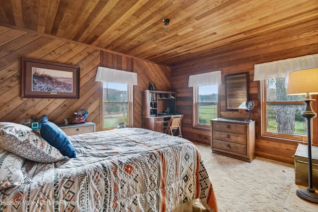 a bedroom with a bed and a wall painting