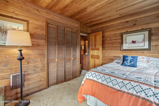 a bedroom with a bed and a desk