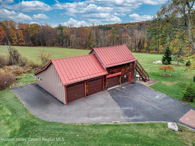 a front view of a house with outdoor seating and flowers