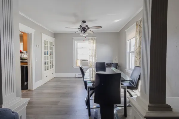 a view of a dining room with furniture window and wooden floor