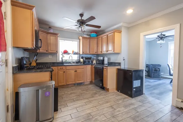 a kitchen with a sink cabinets and window