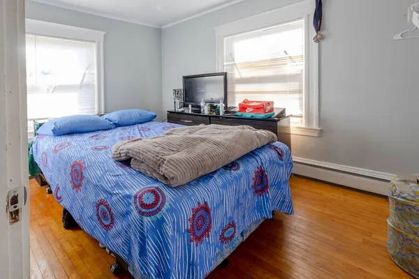 a bedroom with bed and a window