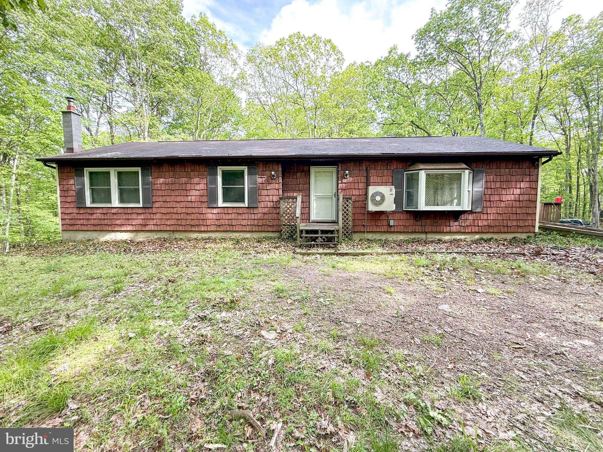 a house that has a tree in front of it