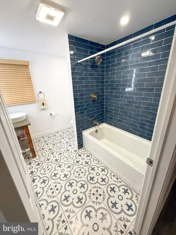 a bathroom with a bathtub and shower