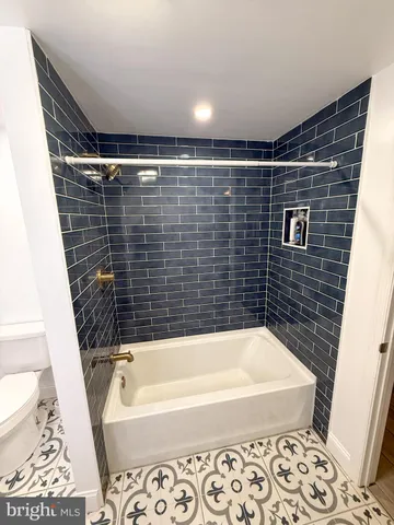 a bathroom with a bathtub and a toilet