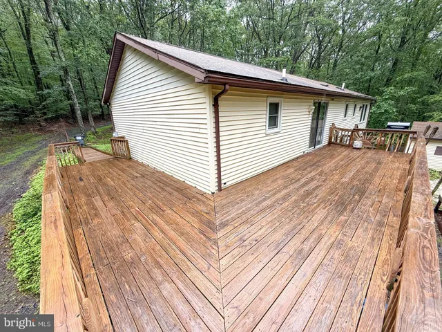 a view of backyard with a deck and wooden floor