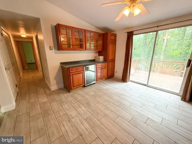 a view of an empty room with window and cabinet