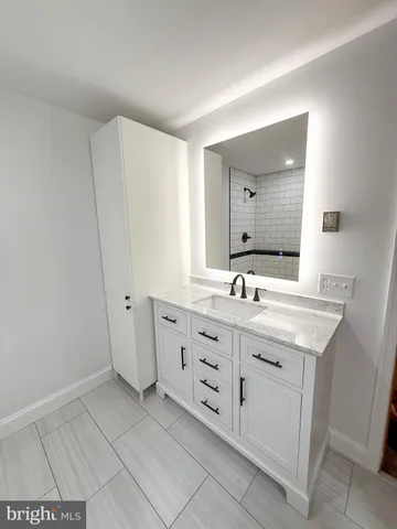a spacious bathroom with a double vanity sink and a mirror