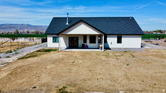 277 West 800 South Monroe, UT 84754 - Photo 41 of 46 Rear view of house with stucco siding, roof with shingles, a water and mountain view, and a patio area