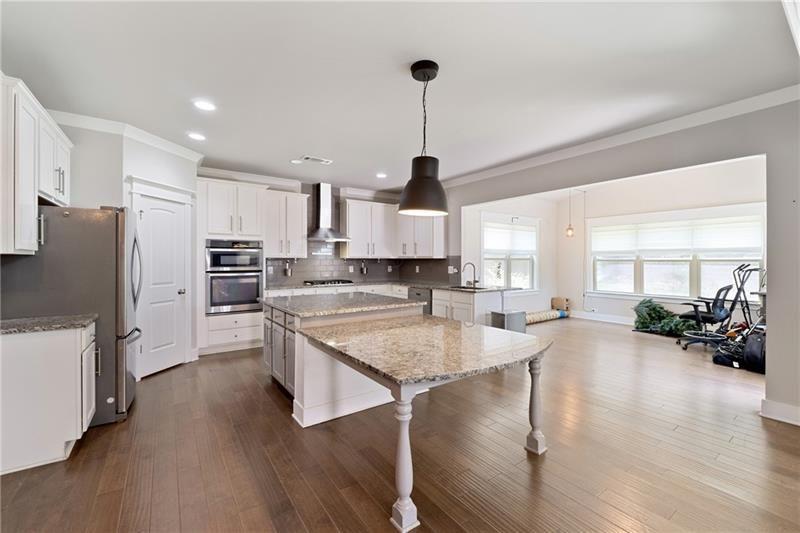 108 Madison Street Canton, GA 30115 - Photo 13 of 43 a kitchen with stainless steel appliances granite countertop a stove a sink a refrigerator and a refrigerator