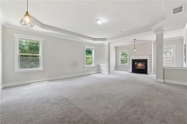 a view of a livingroom with an empty space and a fireplace