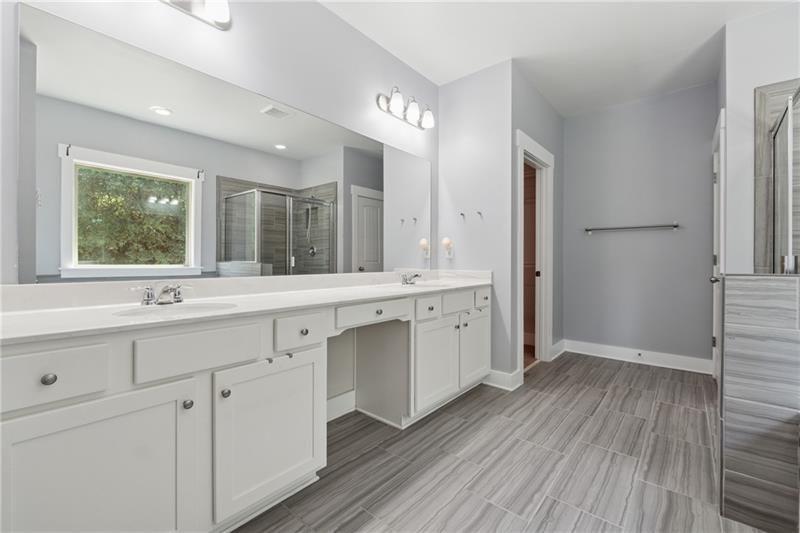 108 Madison Street Canton, GA 30115 - Photo 19 of 43 a spacious bathroom with a double vanity sink a mirror and a shower
