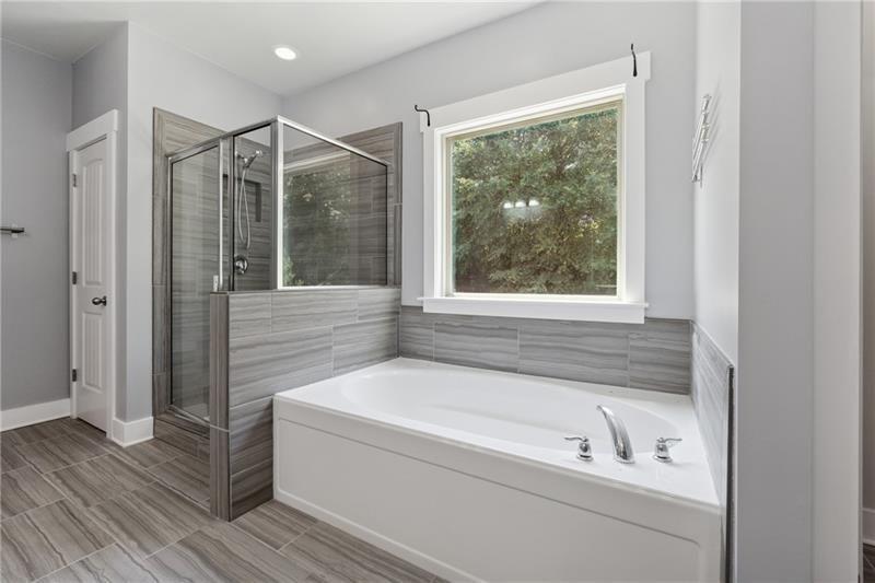 108 Madison Street Canton, GA 30115 - Photo 20 of 43 a bathroom with a bathtub and a shower