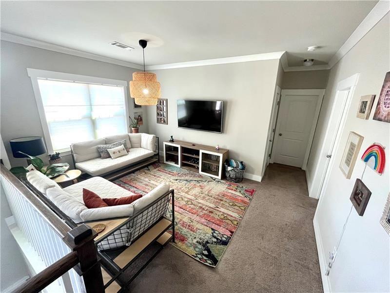 108 Madison Street Canton, GA 30115 - Photo 27 of 43 a living room with furniture and a flat screen tv