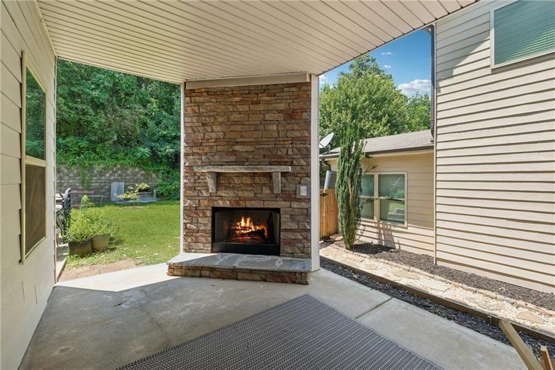 108 Madison Street Canton, GA 30115 - Photo 35 of 43 a living room with a fireplace and a garden