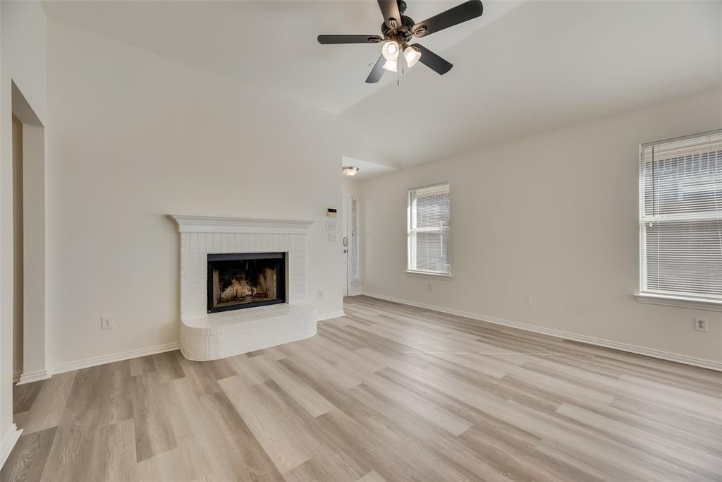 1048 Port Sullivan Drive Little Elm, TX 75068 - Photo 1 of 19 an empty room with windows and fireplace