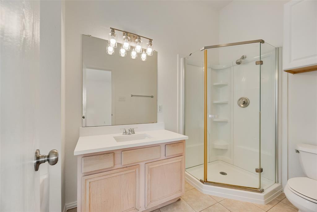 1048 Port Sullivan Drive Little Elm, TX 75068 - Photo 11 of 19 a bathroom with a shower sink vanity and mirror