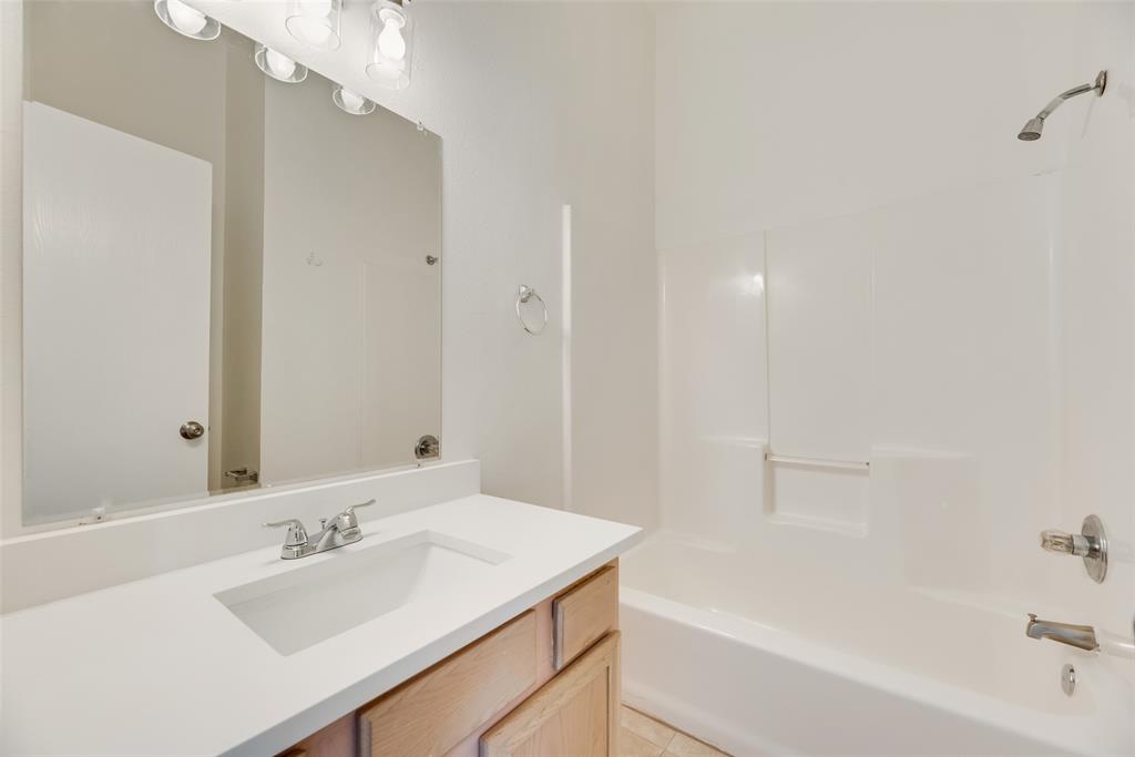 1048 Port Sullivan Drive Little Elm, TX 75068 - Photo 13 of 19 a bathroom with a bathtub and a sink