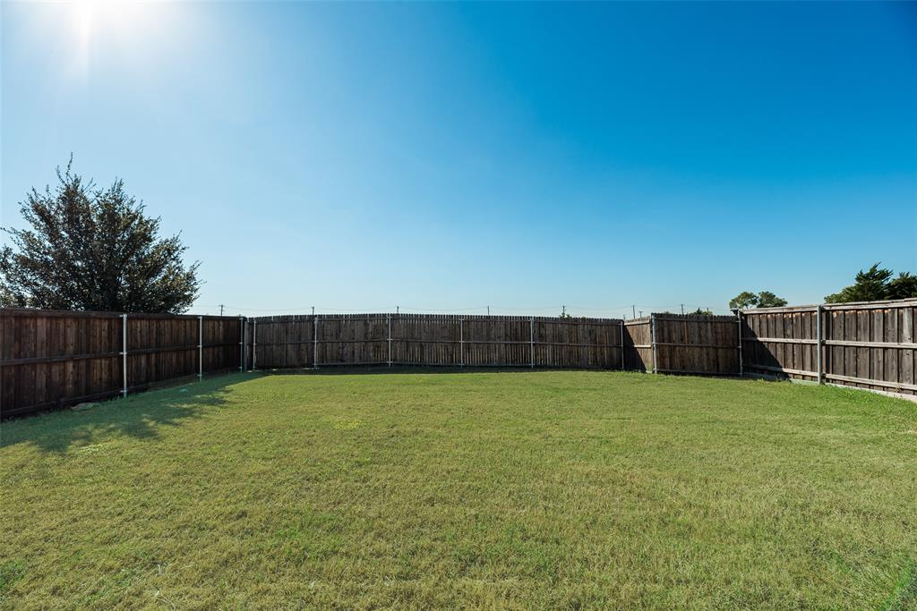 1048 Port Sullivan Drive Little Elm, TX 75068 - Photo 17 of 19 a view of a yard with a fence
