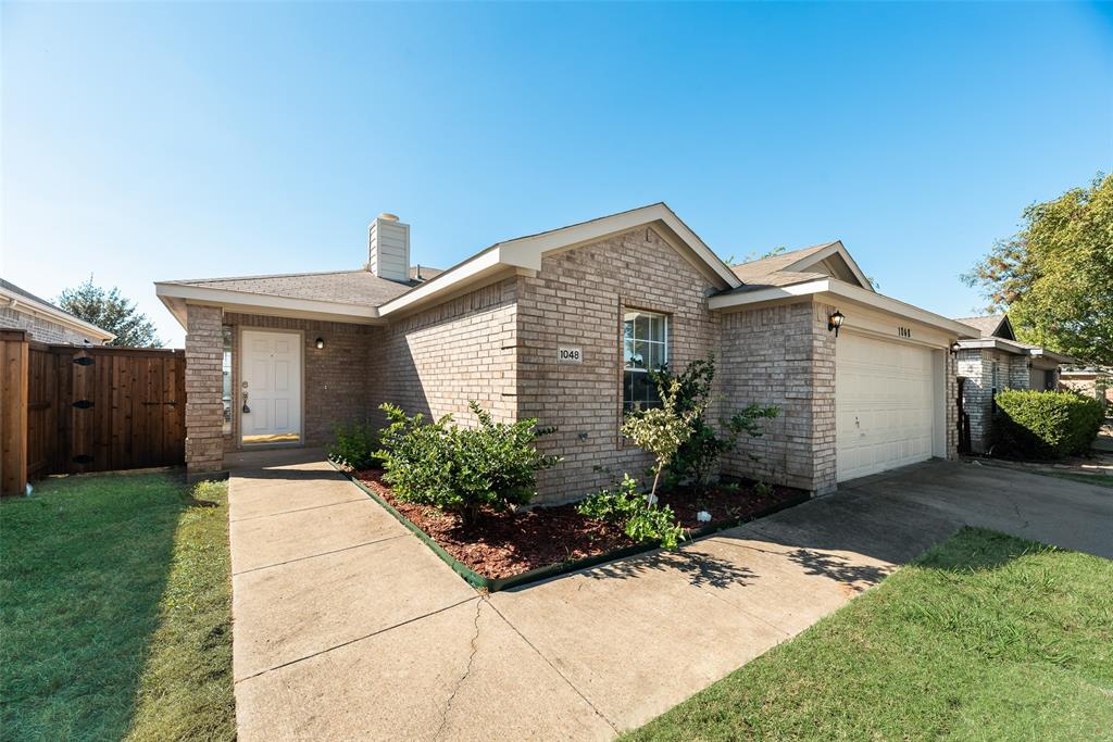 1048 Port Sullivan Drive Little Elm, TX 75068 - Photo 2 of 19 a front view of a house with garden