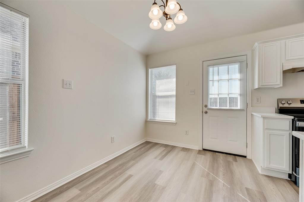 1048 Port Sullivan Drive Little Elm, TX 75068 - Photo 5 of 19 wooden floor in an empty room with a window