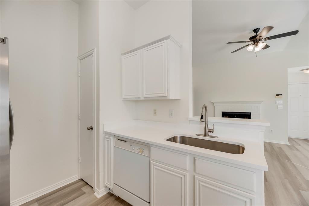 1048 Port Sullivan Drive Little Elm, TX 75068 - Photo 8 of 19 a kitchen with white cabinets and sink